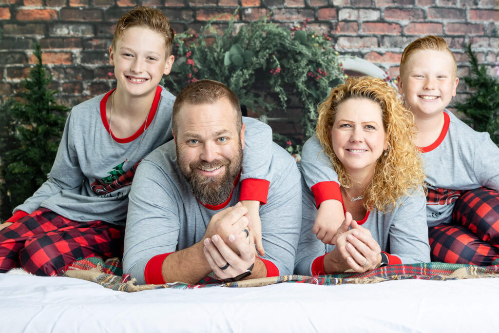 Family of four in Christmas Pjs photo session