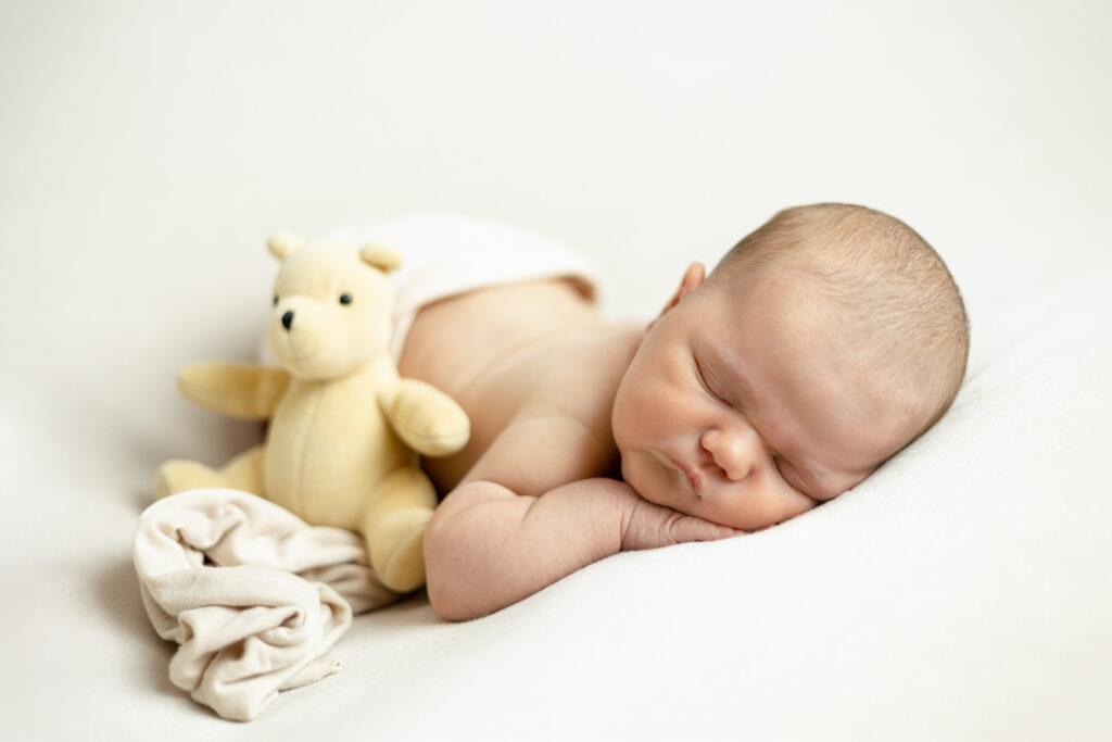 newborn with moms teddy bear from childhood
